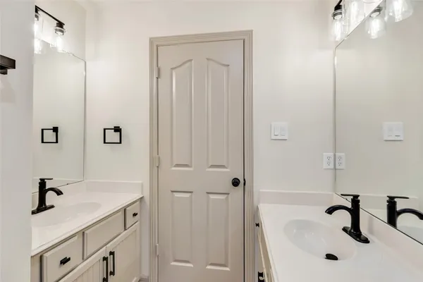 a bathroom with a tub sink and mirror