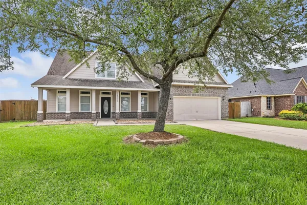 a front view of a house with a garden and yard