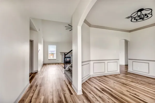 a view of a hallway with wooden floor and staircase