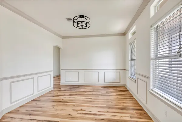 a view of a room with wooden floor and white walls