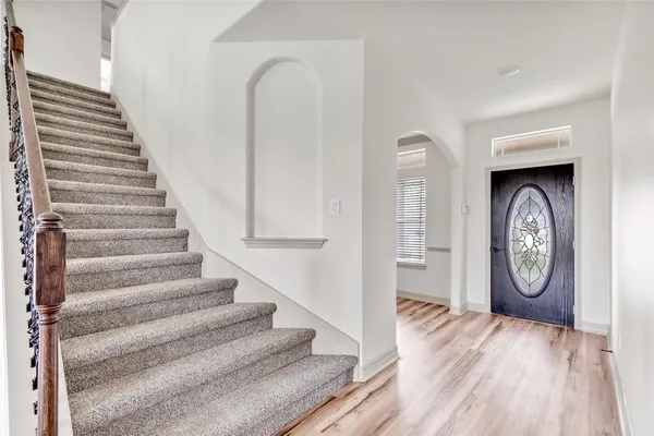 a view of a hallway with wooden floor
