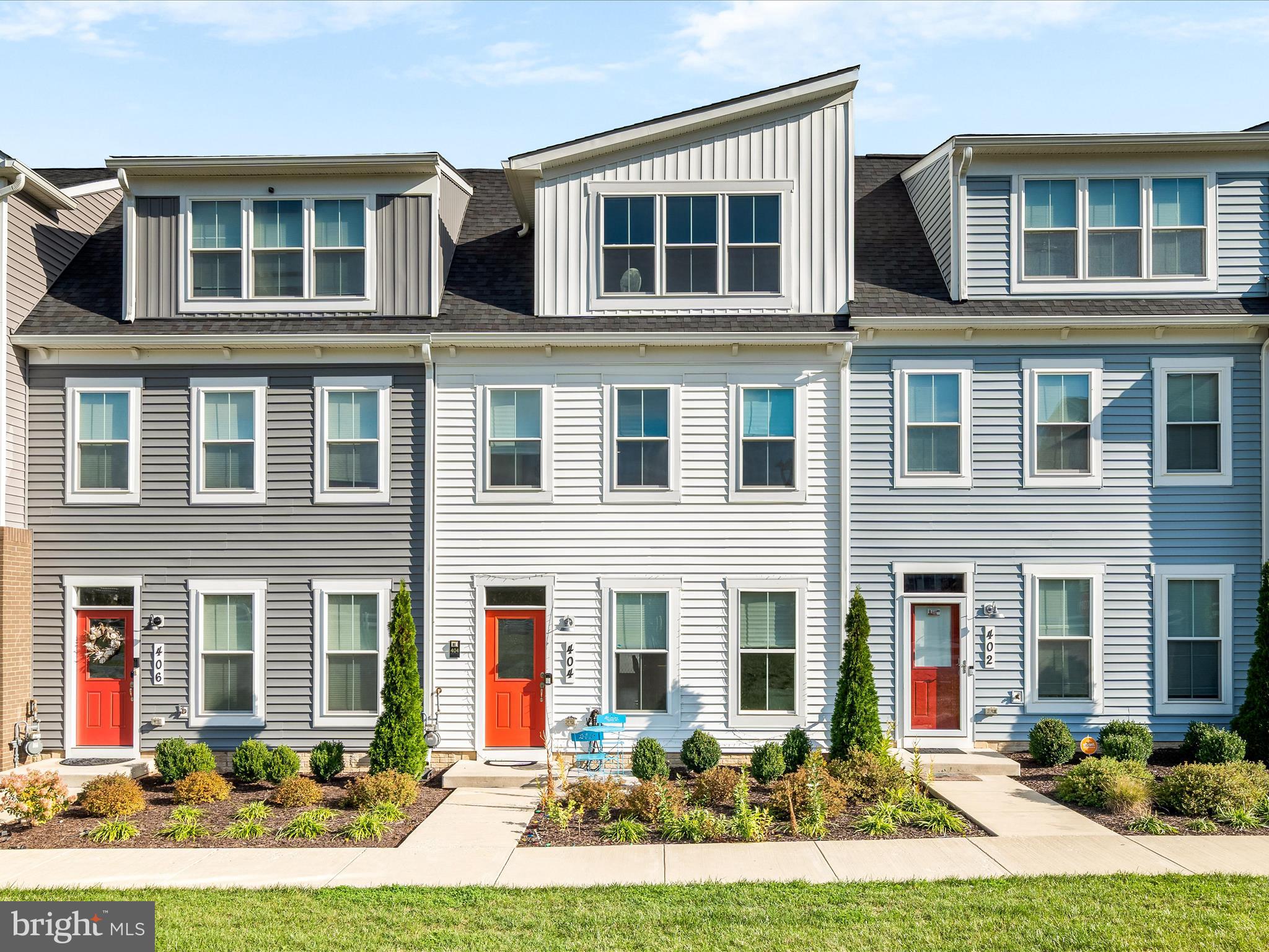 a front view of a residential apartment building with a yard