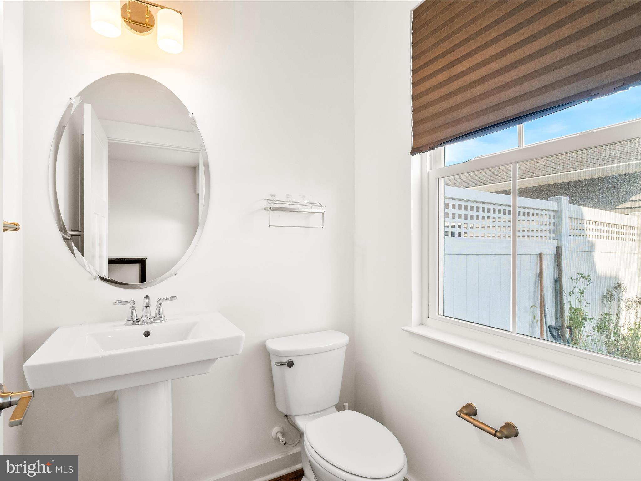 404 Waverley Drive Frederick, MD 21702 - Photo 12 of 28 a bathroom with a toilet a sink and a large mirror