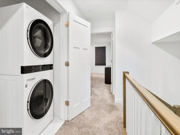 a view of a hallway with washer and dryer
