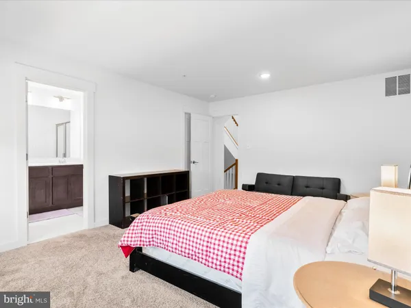a bedroom with a bed and a mirror