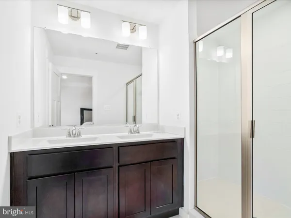 a bathroom with a double vanity sink and mirror