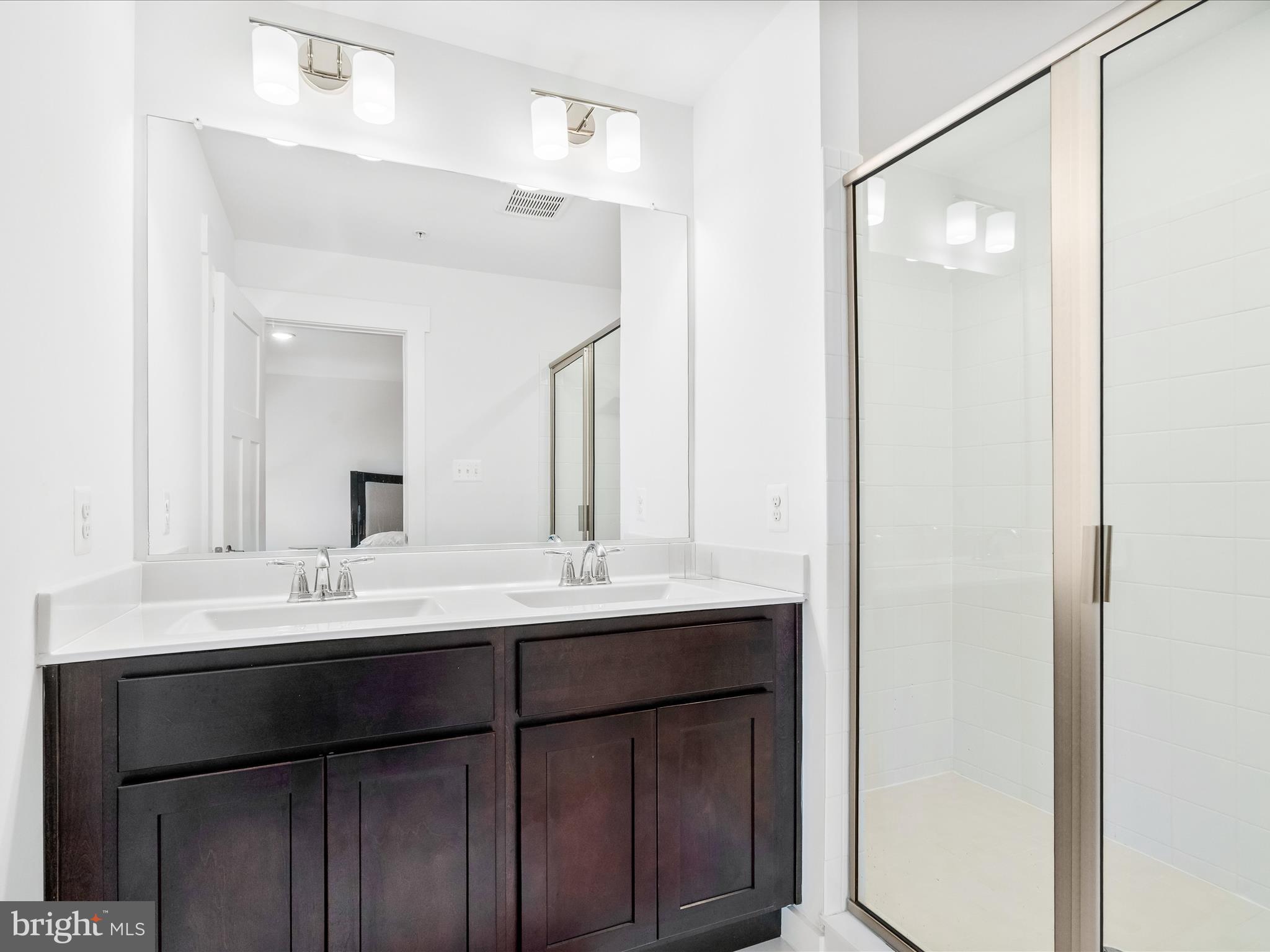404 Waverley Drive Frederick, MD 21702 - Photo 16 of 28 a bathroom with a double vanity sink and mirror
