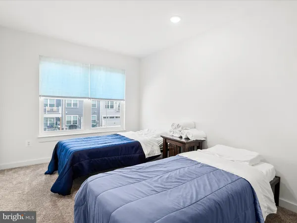 a bedroom with two beds and a window