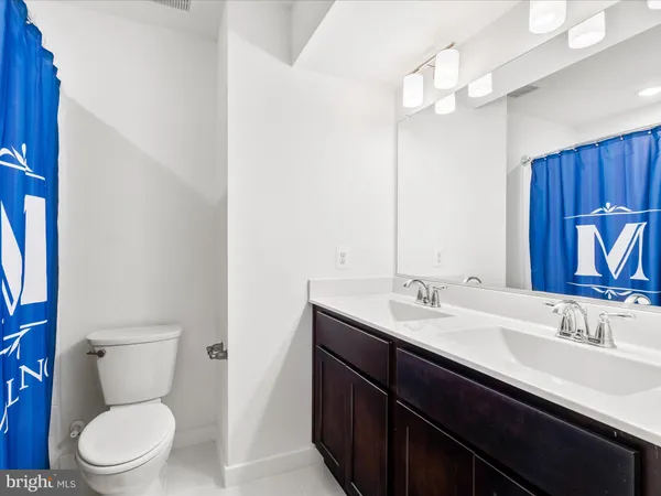 a bathroom with a toilet a sink and a mirror