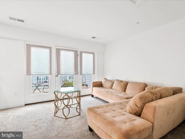 a living room with furniture and large windows