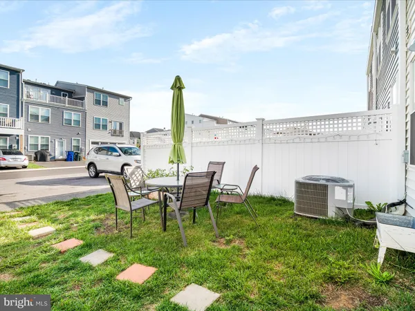 a view of a patio with table and chairs