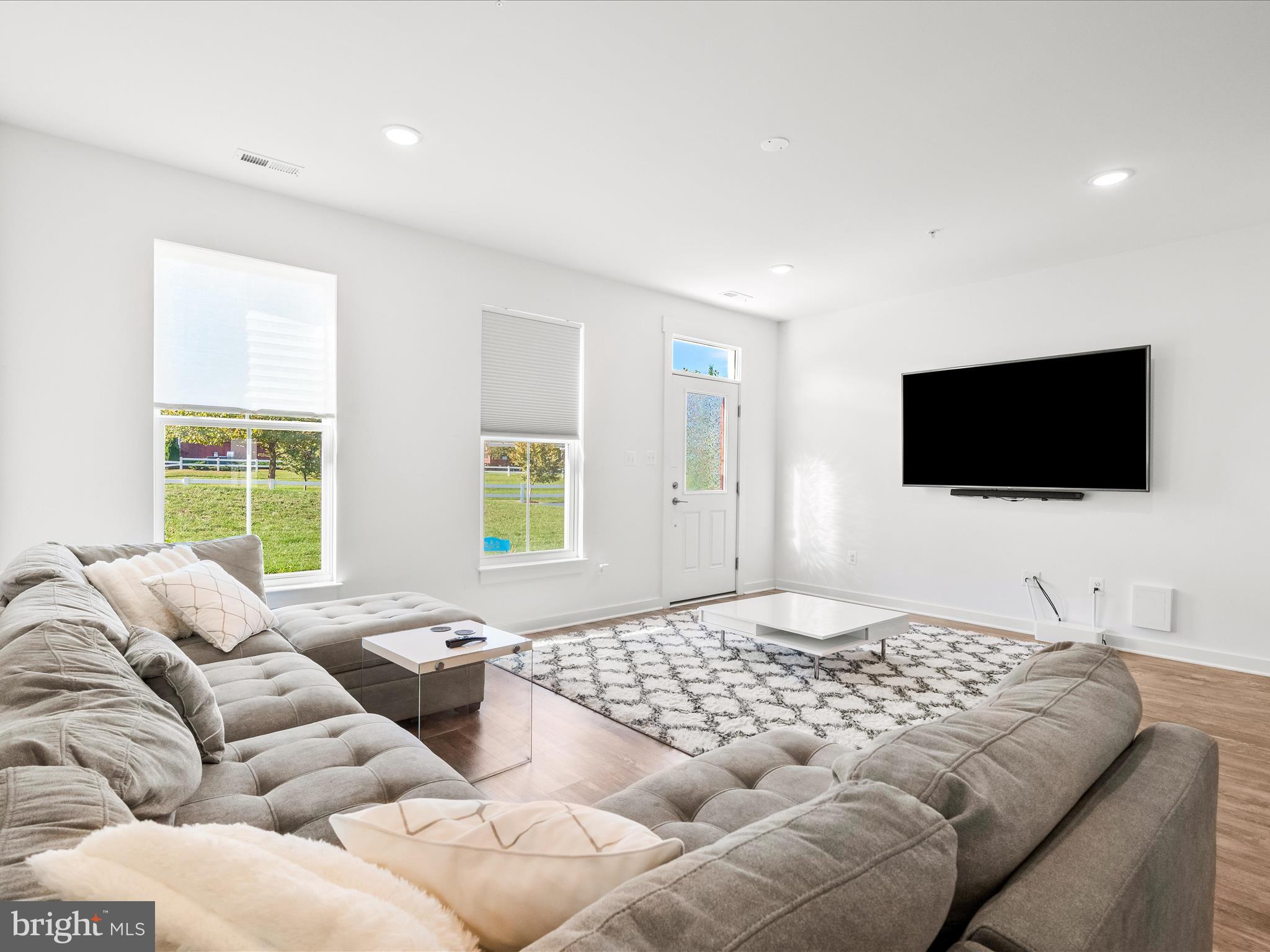 404 Waverley Drive Frederick, MD 21702 - Photo 7 of 28 a bedroom with a bed and a flat screen tv