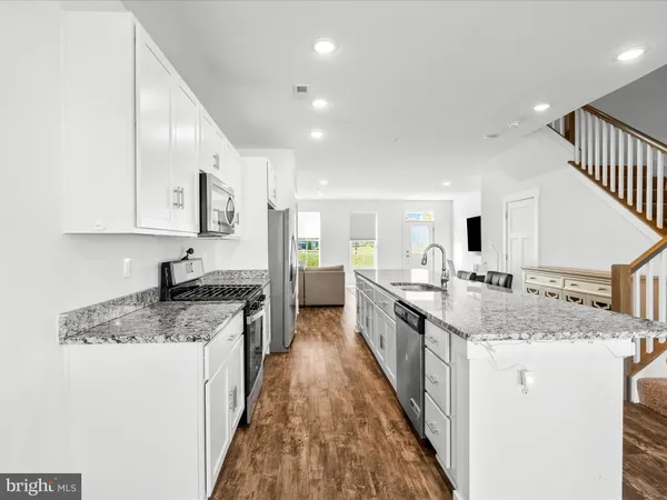 a large kitchen with stainless steel appliances lots of counter top space and cabinets