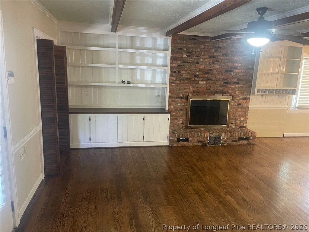 2515 Fort Bragg Road Fayetteville, NC 28303 - Photo 6 of 23 an empty room with wooden floor and fireplace
