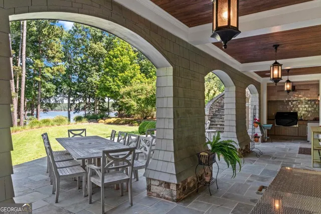 a view of a swimming pool with outdoor seating and a porch
