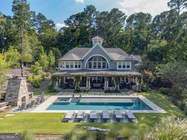 a house with swimming pool in front of it