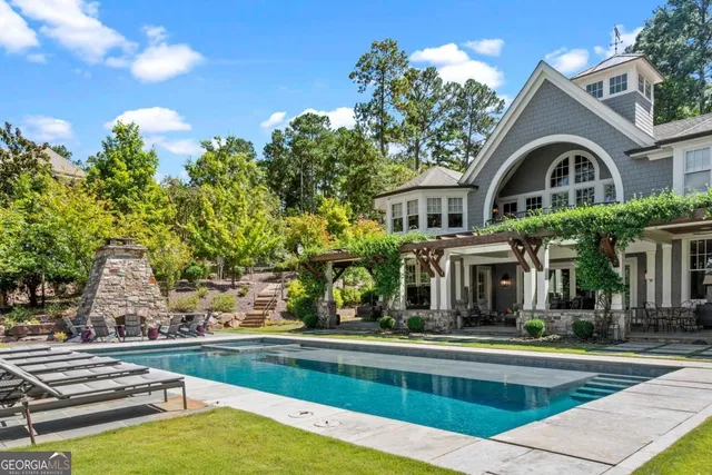 a front view of house with yard and swimming pool
