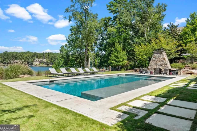 a view of swimming pool with outdoor seating and plants