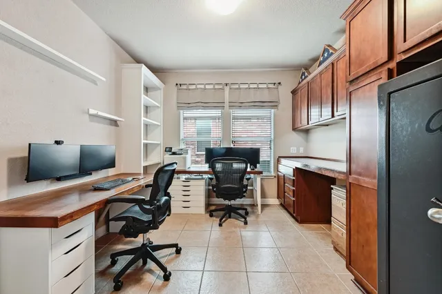 a view of a workspace with furniture and a window