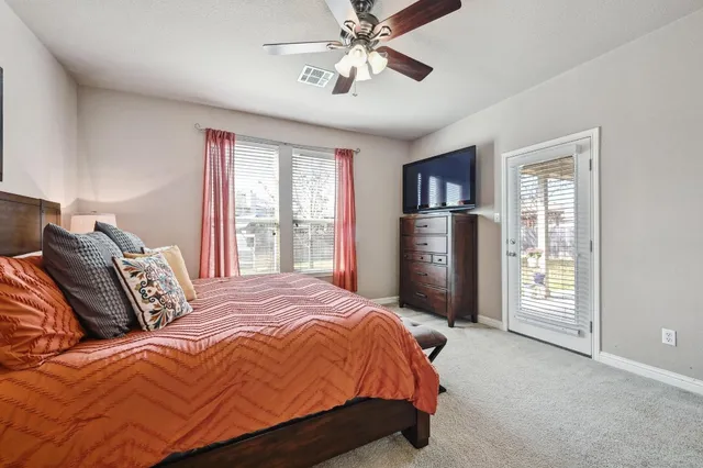 a bedroom with a bed dresser and a window