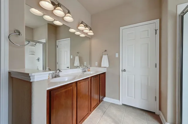 a bathroom with a double vanity sink and a mirror