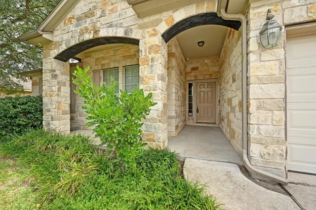 front view of a brick house with a large windows