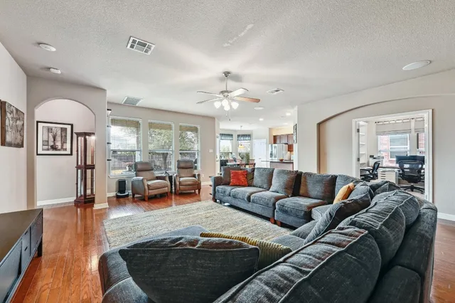 a living room with furniture and wooden floor