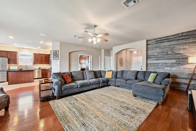 a living room with furniture and wooden floor