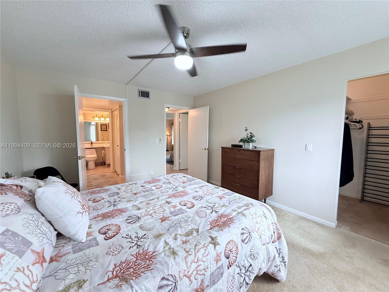 340 Pine Ridge Circle, Unit C1 Greenacres, FL 33463 - Photo 11 of 24 a bedroom with a bed and a dresser