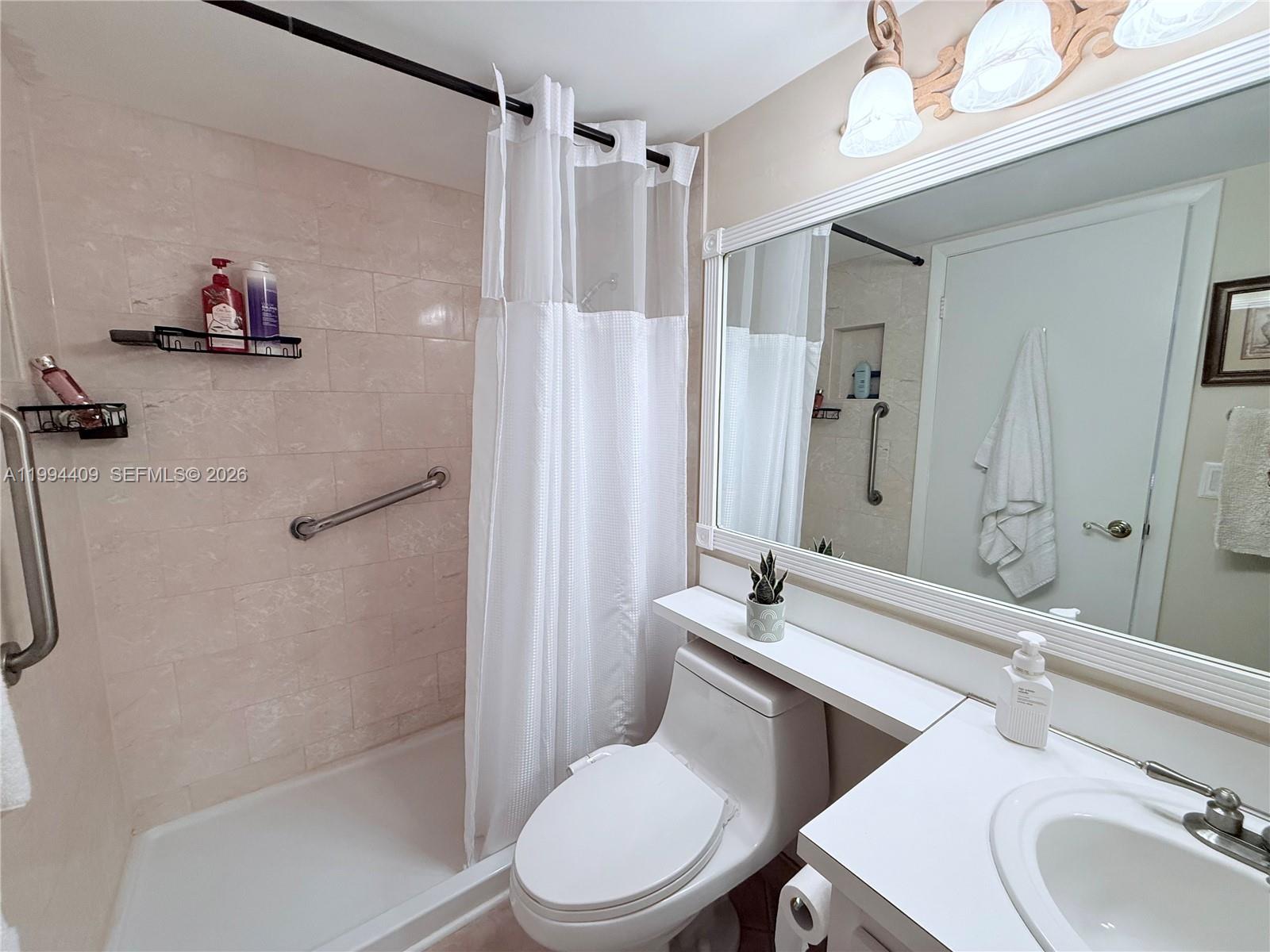 340 Pine Ridge Circle, Unit C1 Greenacres, FL 33463 - Photo 20 of 24 a bathroom with a sink toilet and shower