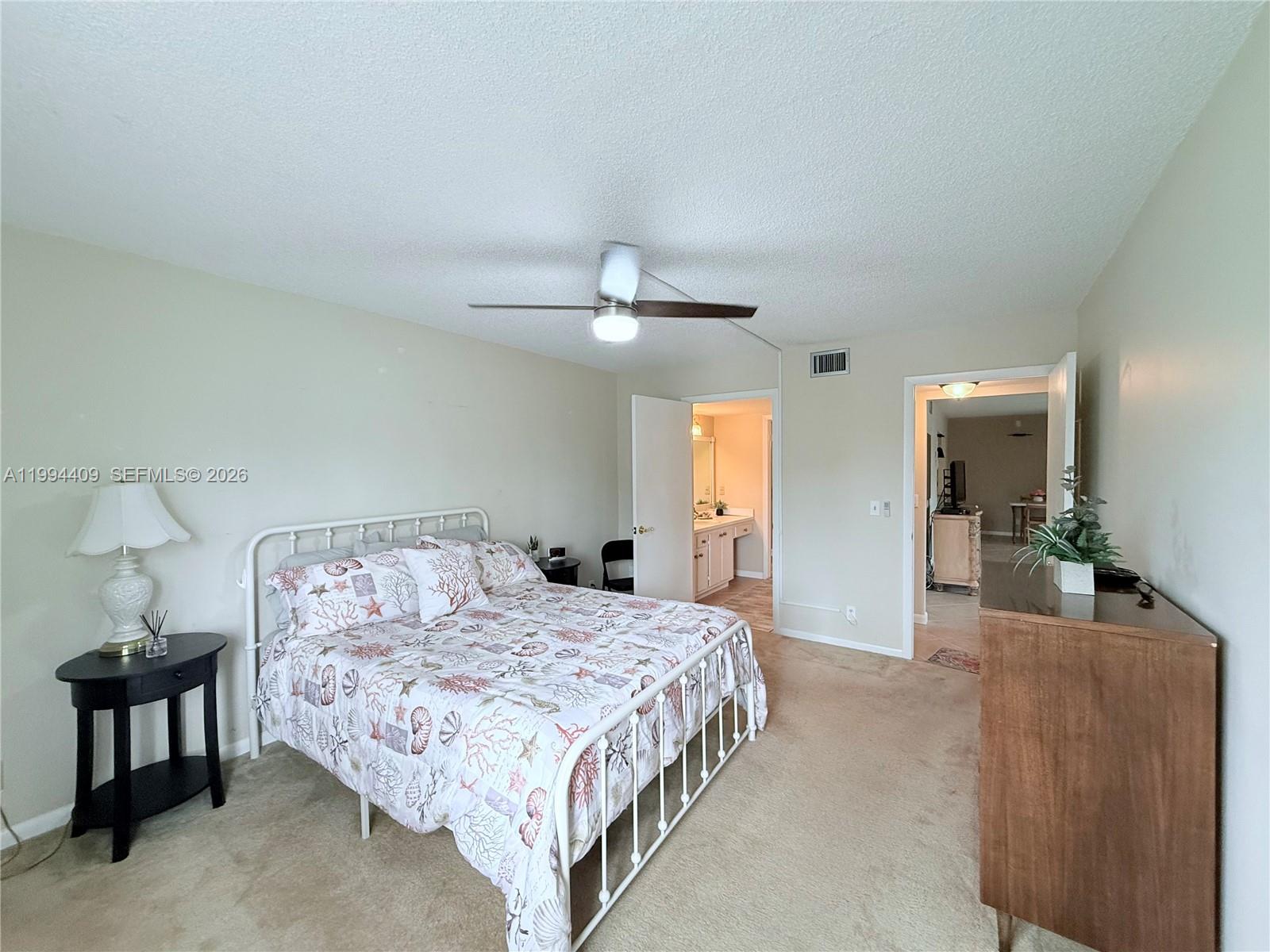 340 Pine Ridge Circle, Unit C1 Greenacres, FL 33463 - Photo 24 of 24 a bedroom with a bed and a mirror