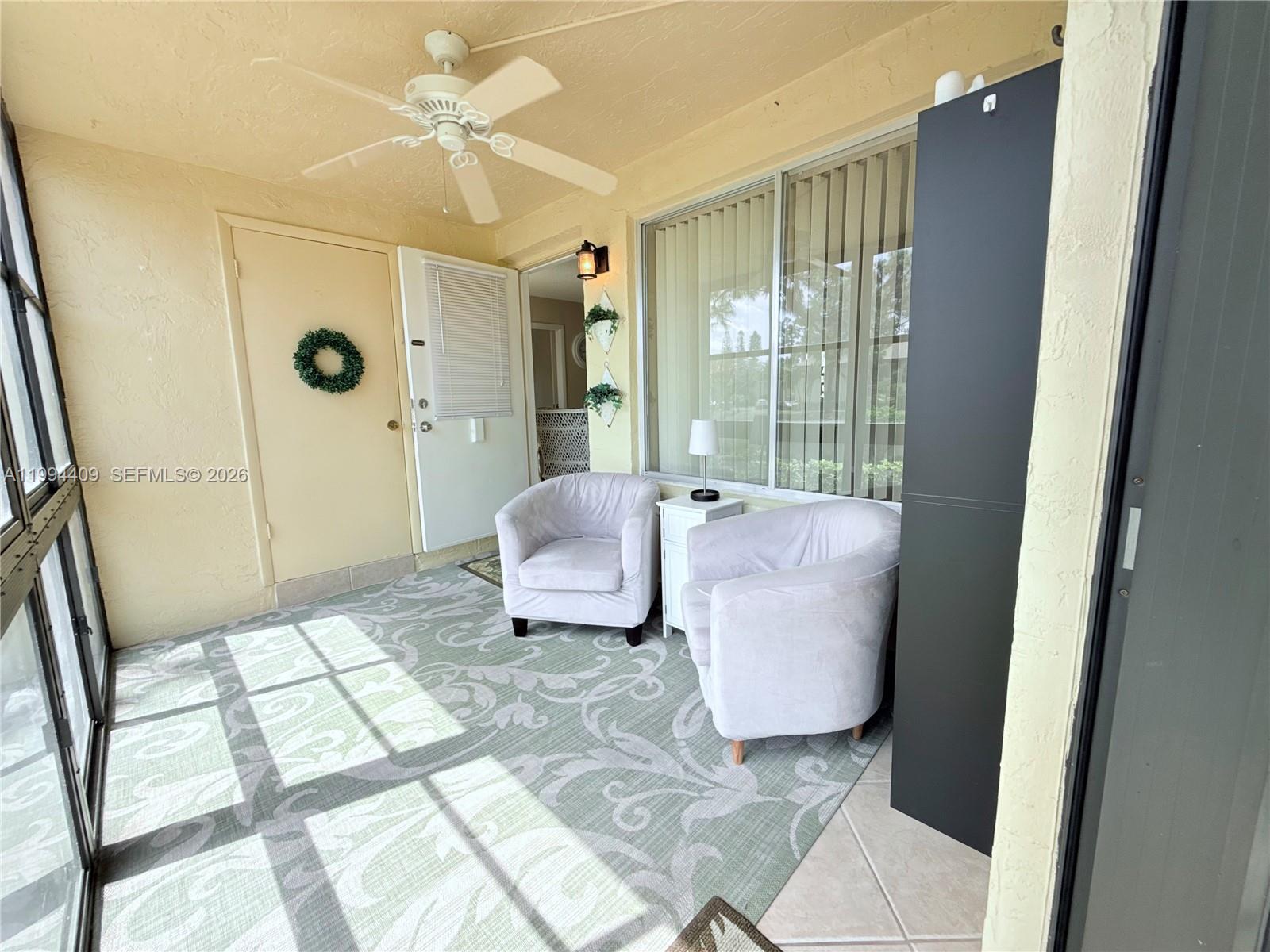 340 Pine Ridge Circle, Unit C1 Greenacres, FL 33463 - Photo 3 of 24 a bathroom with a glass shower door and a mirror