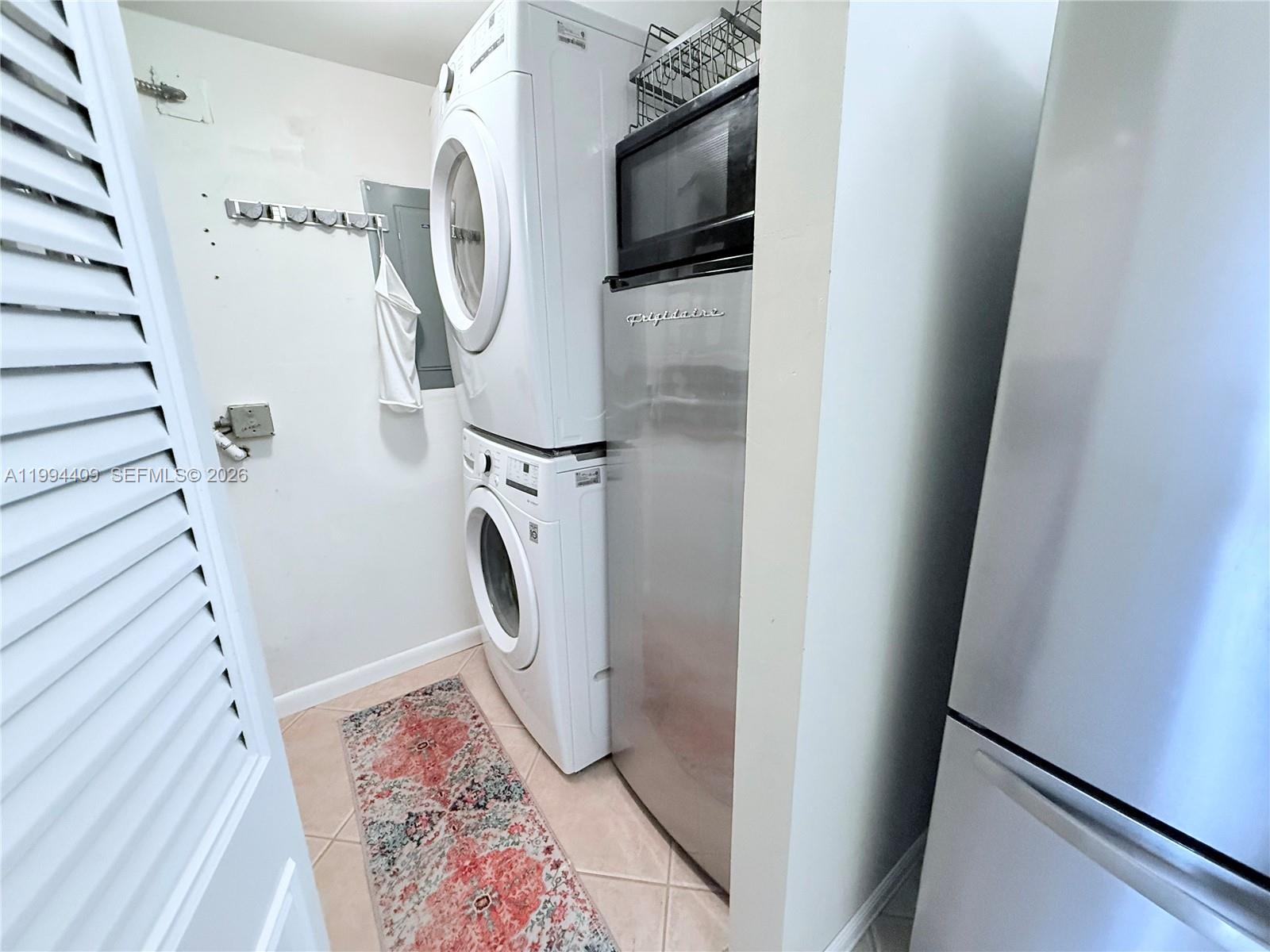 340 Pine Ridge Circle, Unit C1 Greenacres, FL 33463 - Photo 7 of 24 a view of walk in closet with clothes washer and dryer