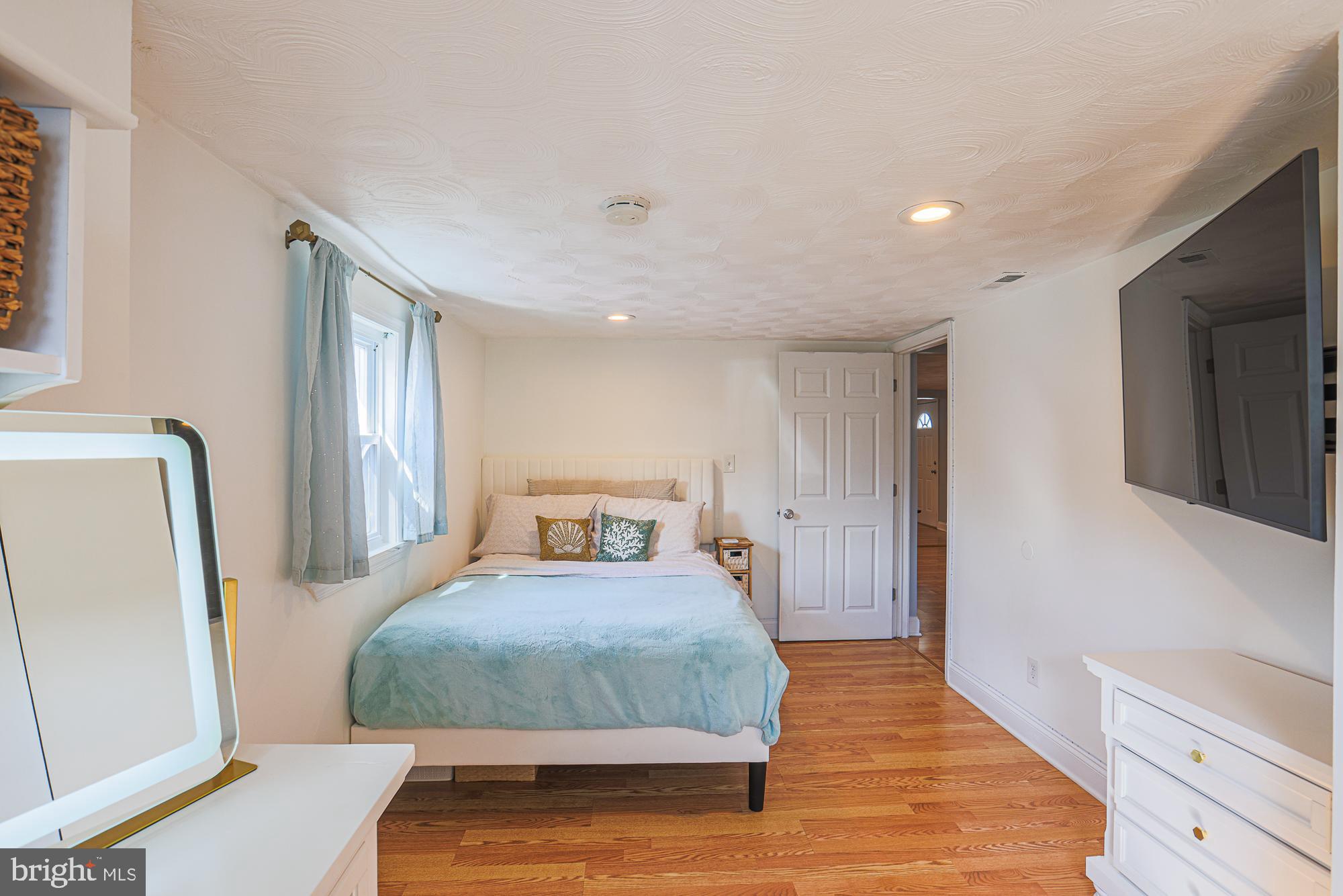 2519 Sycamore Avenue Baltimore, MD 21219 - Photo 15 of 30 a bedroom with a bed and a mirror