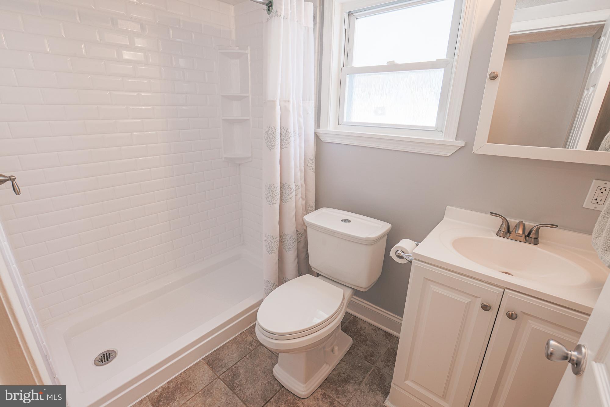 2519 Sycamore Avenue Baltimore, MD 21219 - Photo 17 of 30 a white toilet sitting next to a bathroom sink