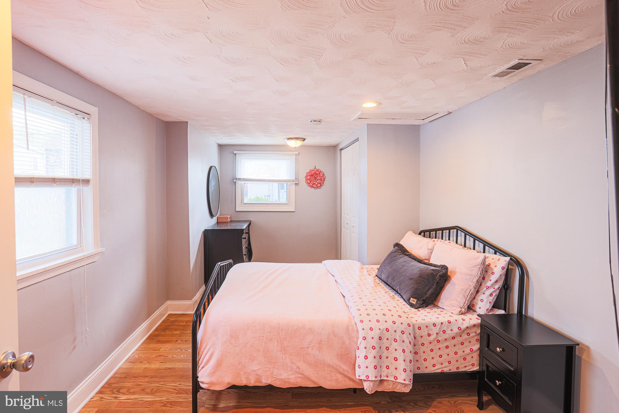 2519 Sycamore Avenue Baltimore, MD 21219 - Photo 18 of 30 a bedroom with a bed and wooden floor