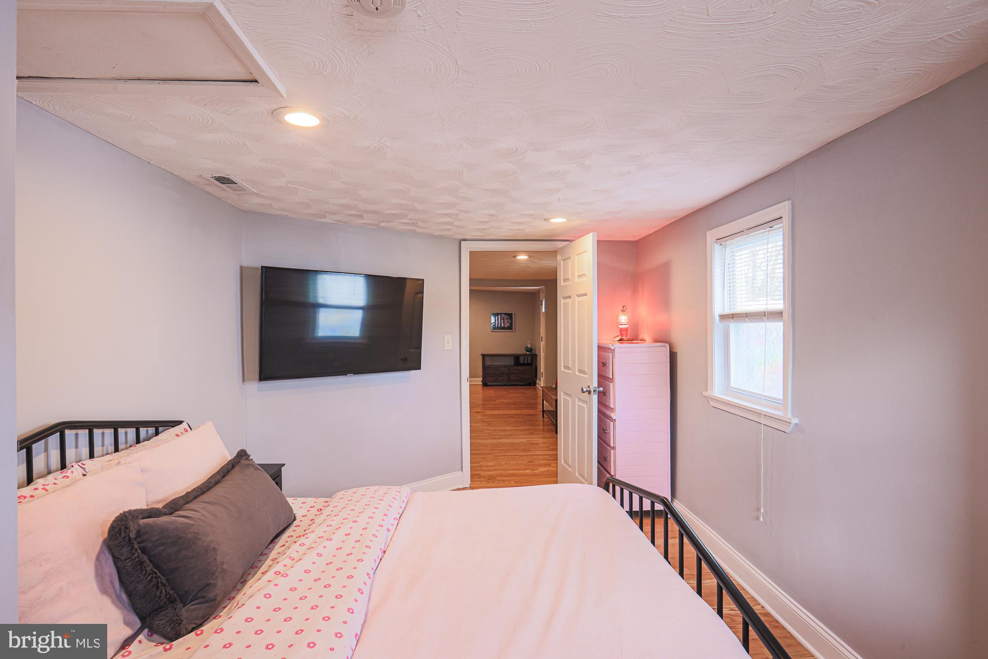 2519 Sycamore Avenue Baltimore, MD 21219 - Photo 20 of 30 a bedroom with a bed and a flat screen tv