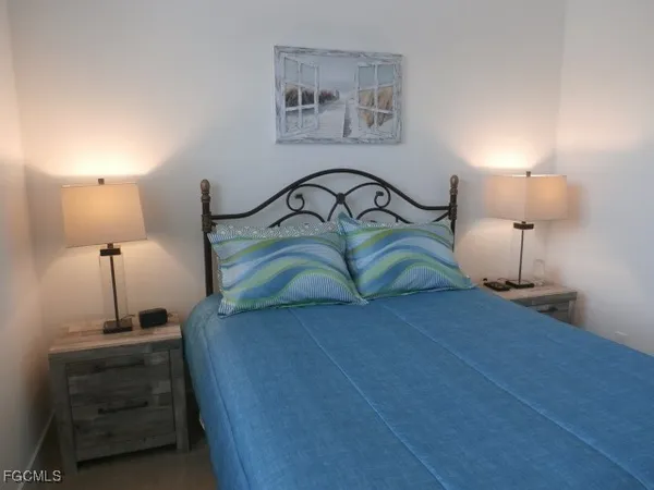 a bedroom with a bed and a night stand