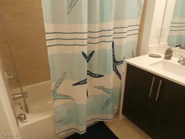 a bathroom with a sink and a shower curtain