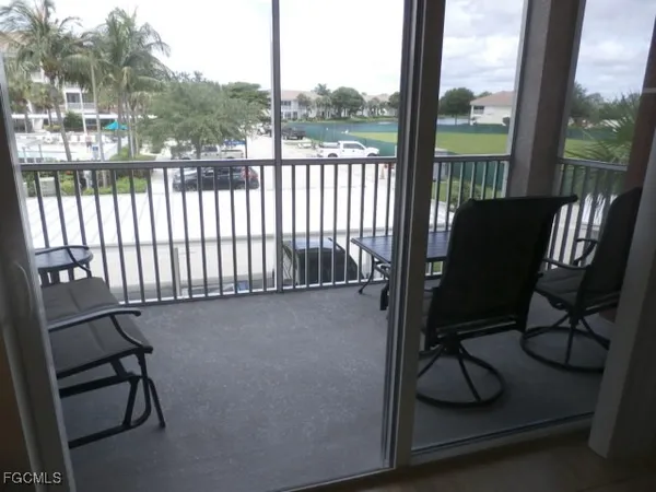a view of a balcony with chair and wooden floor