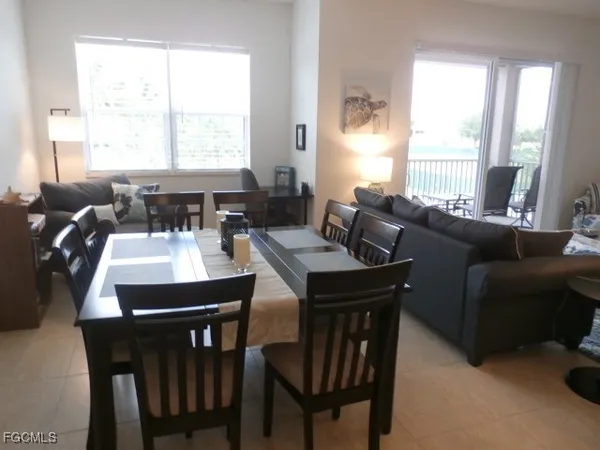 a view of a dining room with furniture and a large window