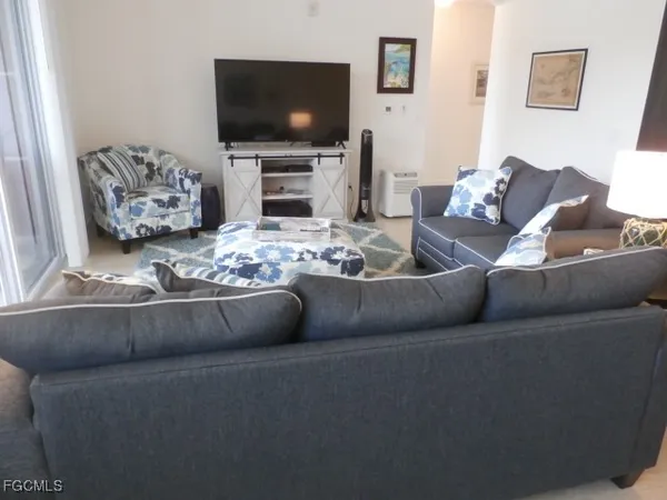 a living room with furniture and a flat screen tv