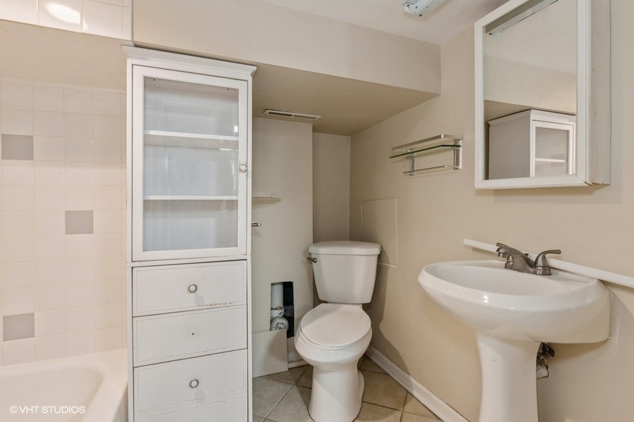 1840 West Huron Street, Unit 1 Chicago, IL 60622 - Photo 13 of 16 a bathroom with a toilet a sink and mirror
