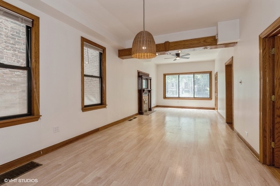 1840 West Huron Street, Unit 1 Chicago, IL 60622 - Photo 4 of 16 a view of an empty room with wooden floor and a window