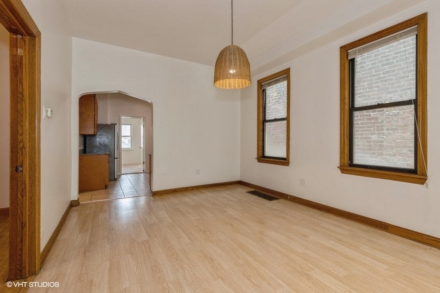 1840 West Huron Street, Unit 1 Chicago, IL 60622 - Photo 7 of 16 a view of empty room with wooden floor and fan