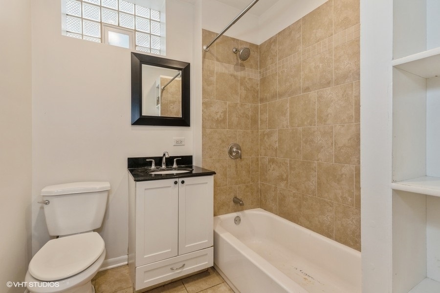 1840 West Huron Street, Unit 1 Chicago, IL 60622 - Photo 8 of 16 a bathroom with a toilet a sink and bathtub