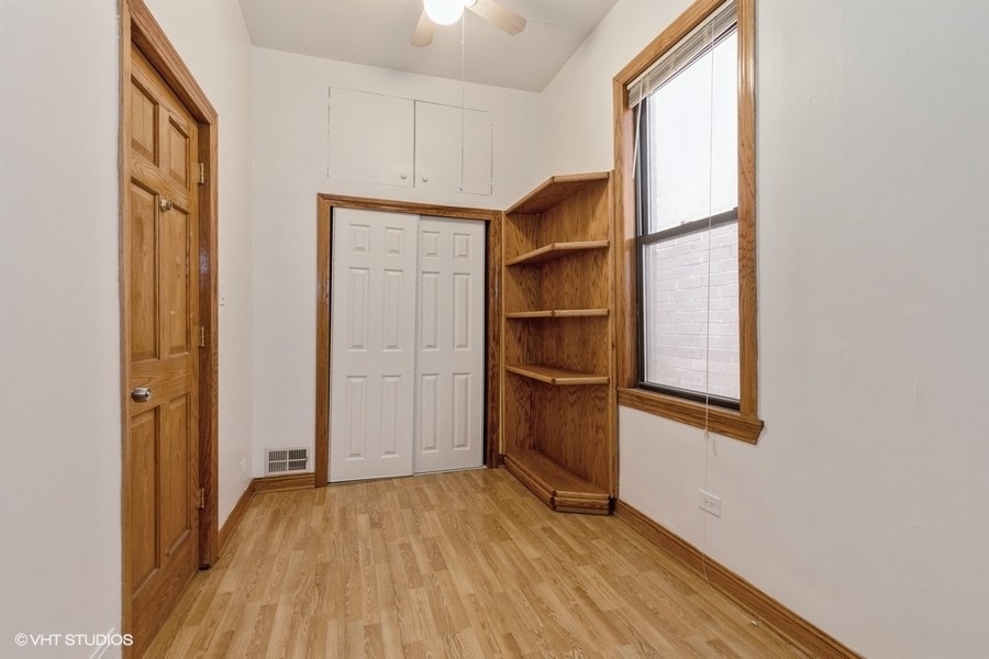 1840 West Huron Street, Unit 1 Chicago, IL 60622 - Photo 9 of 16 a view of walk in closet with empty racks