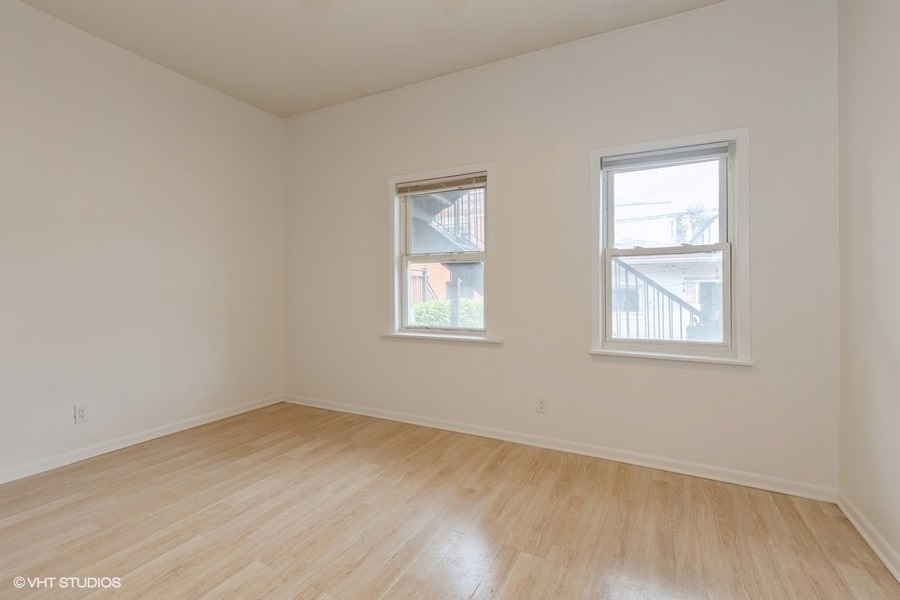 1840 West Huron Street, Unit 1 Chicago, IL 60622 - Photo 10 of 16 a view of an empty room with wooden floor and a window