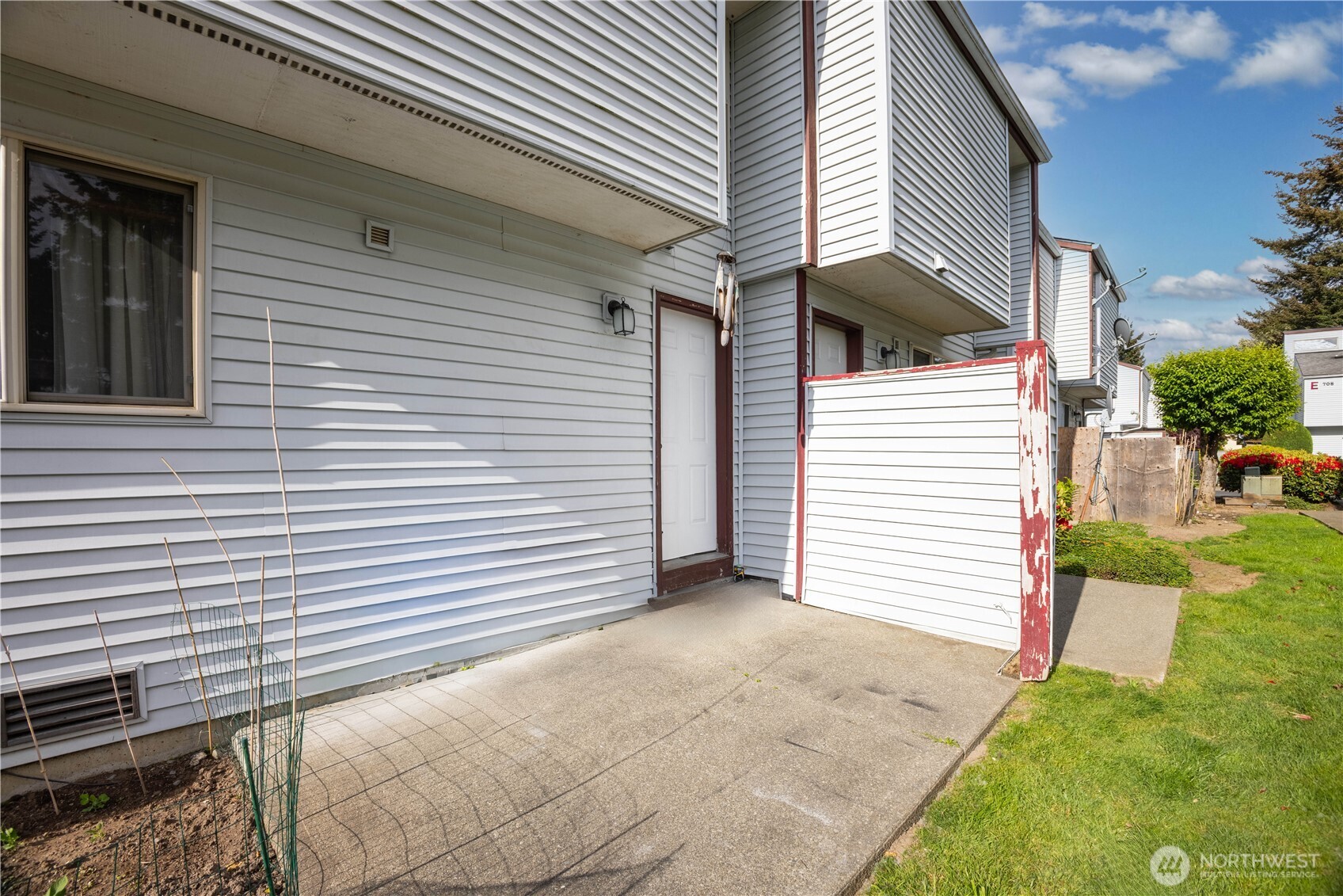 701 5th Avenue South, Unit C105 Kent, WA 98032 - Photo 27 of 31 a view of a house with a yard and garage