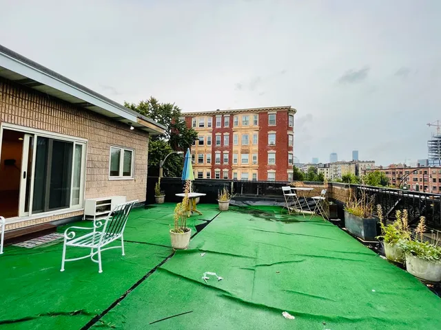 a view of a house with a backyard porch and sitting area